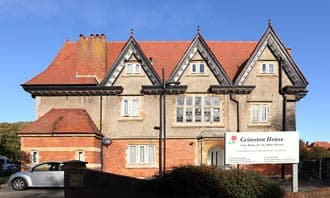Grimston House, a red-brick and render Victorian house with steep gables on Grimston Gardens